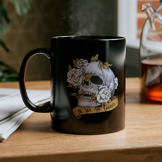 Black mug with skull design on a wooden table