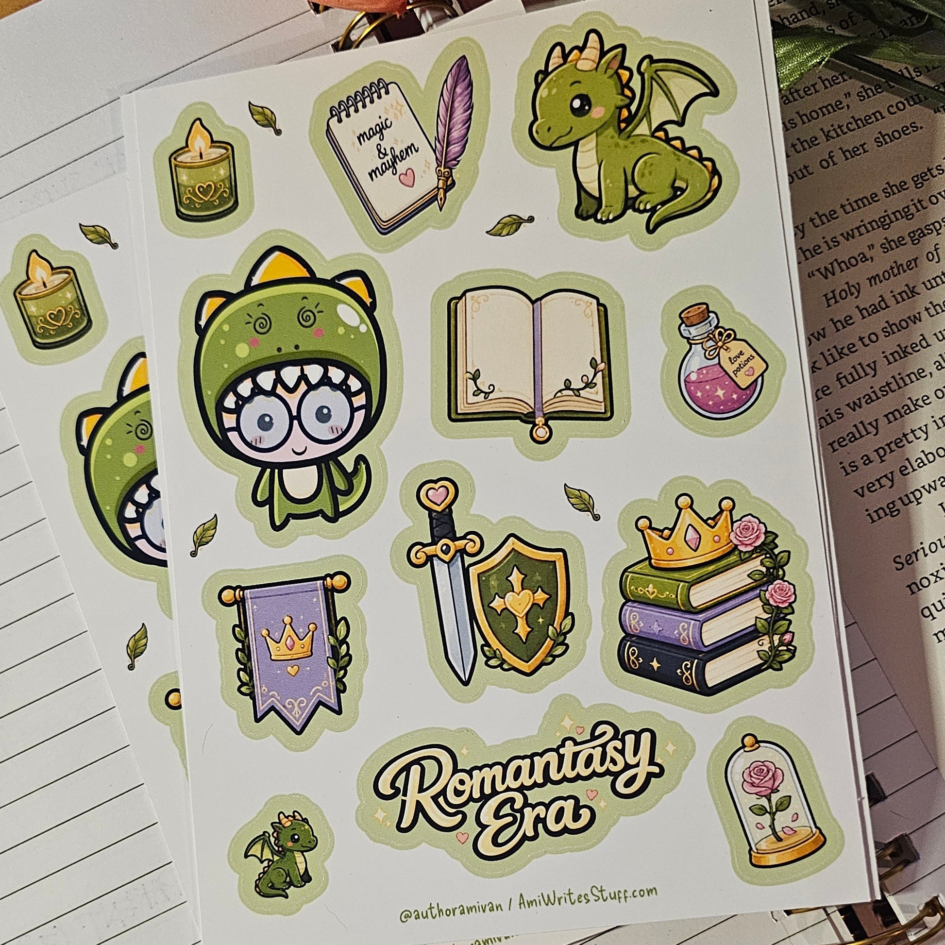 A sheet of cute fantasy-themed planner stickers displayed on top of lined notebook pages with flowers and a red fabric background.